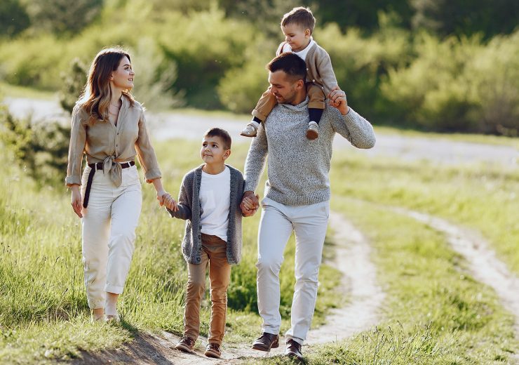 Cute family playing in a summer field